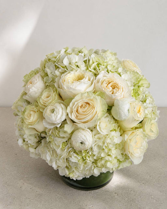 White Floral Arrangement in a Round Glass Vase